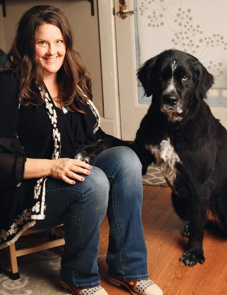 A picture of Stacy with a black dog